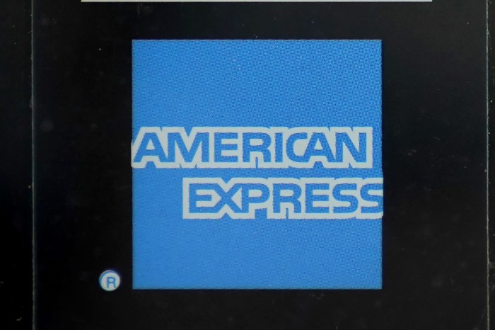 Amex profits fall as higher spending offset by loan losses